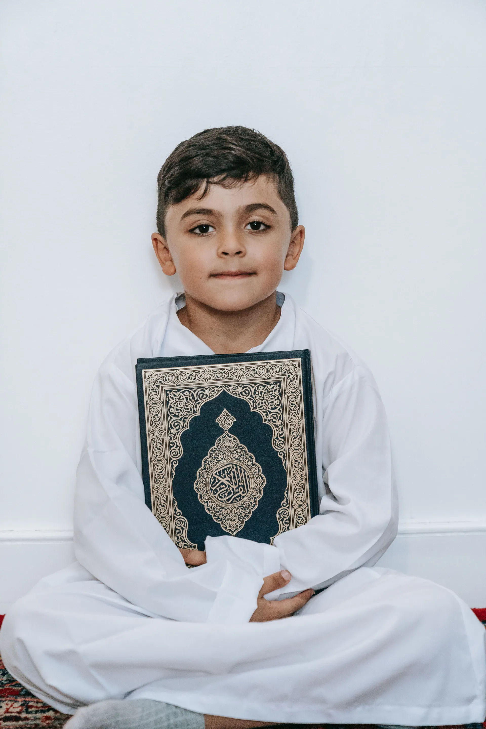 Young student holding the Holy Quran